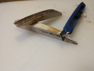 Shaping the wing tips with a knife to remove the bulk of material.